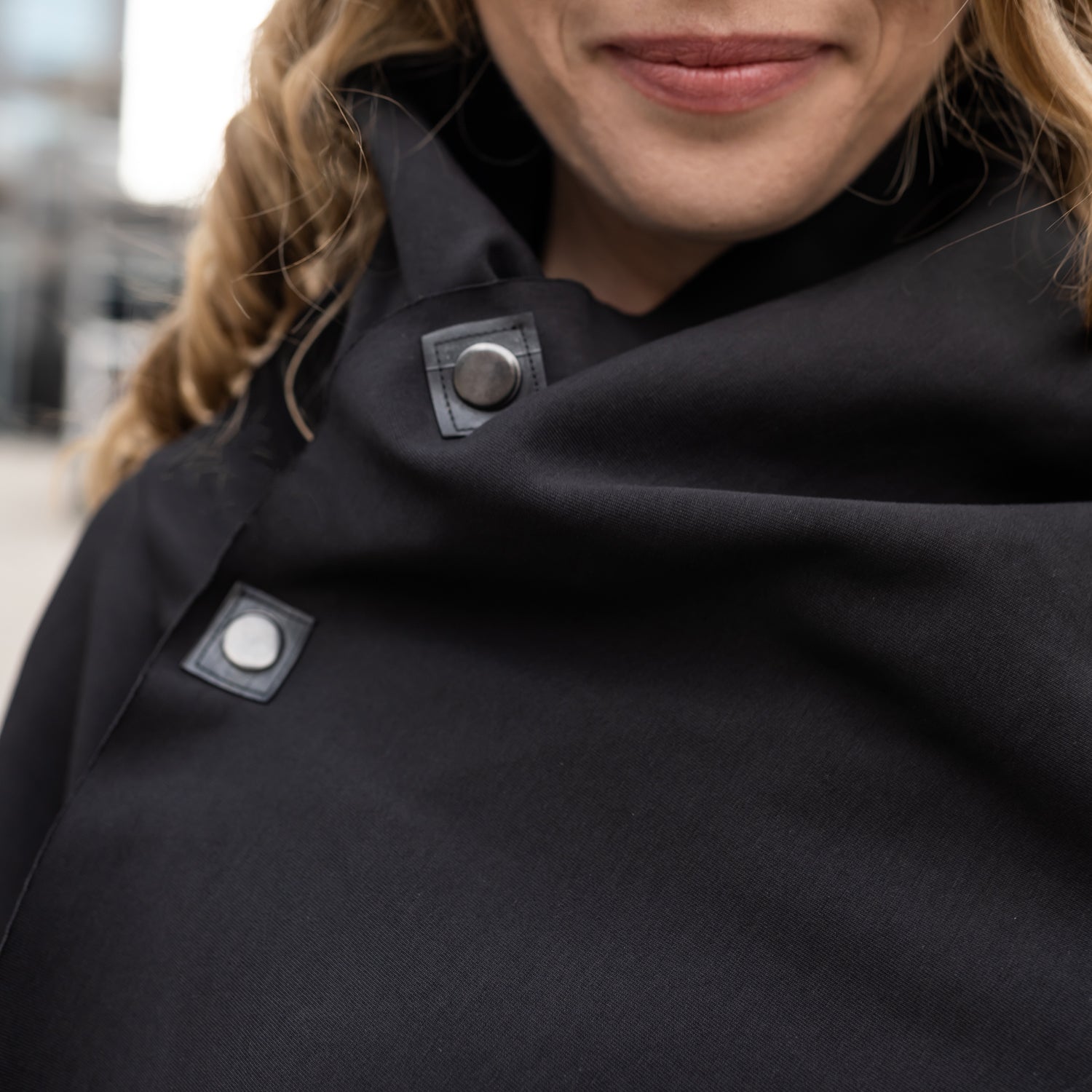 A close up of a woman wearing a black shift dress by Malaika New York