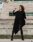 A woman wearing a long black organic cotton cardigan by Malaika New York
