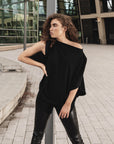 A woman wearing a off shoulder t-shirt in organic cotton-oversized