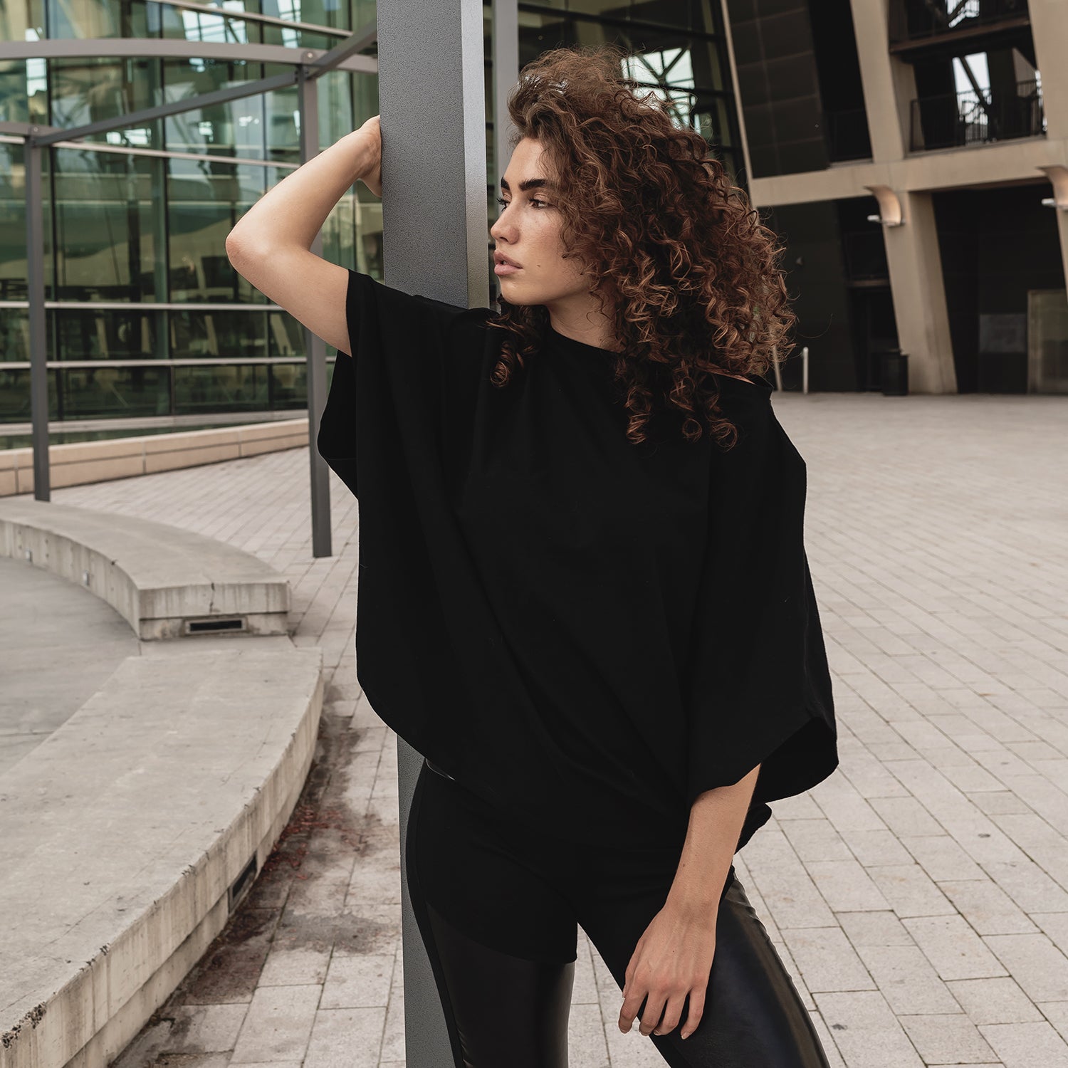 A woman wearing a comfortable oversized organic cotton black t-shirt by Malaika New York