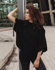 A woman wearing a comfortable oversized organic cotton black t-shirt by Malaika New York