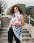 A woman wearing an asymmetrical linen hand painted vest by Malaika New York x Tato