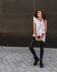A woman wearing a linen vest and faux leather leggings a sustainable look by Malaika New York