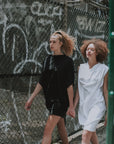 Two Models walking wearing our white & black shift dress in organic cotton. Made by Malaika New York