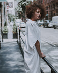 Model wearing our white shift dress in organic cotton. Made by Malaika New York
