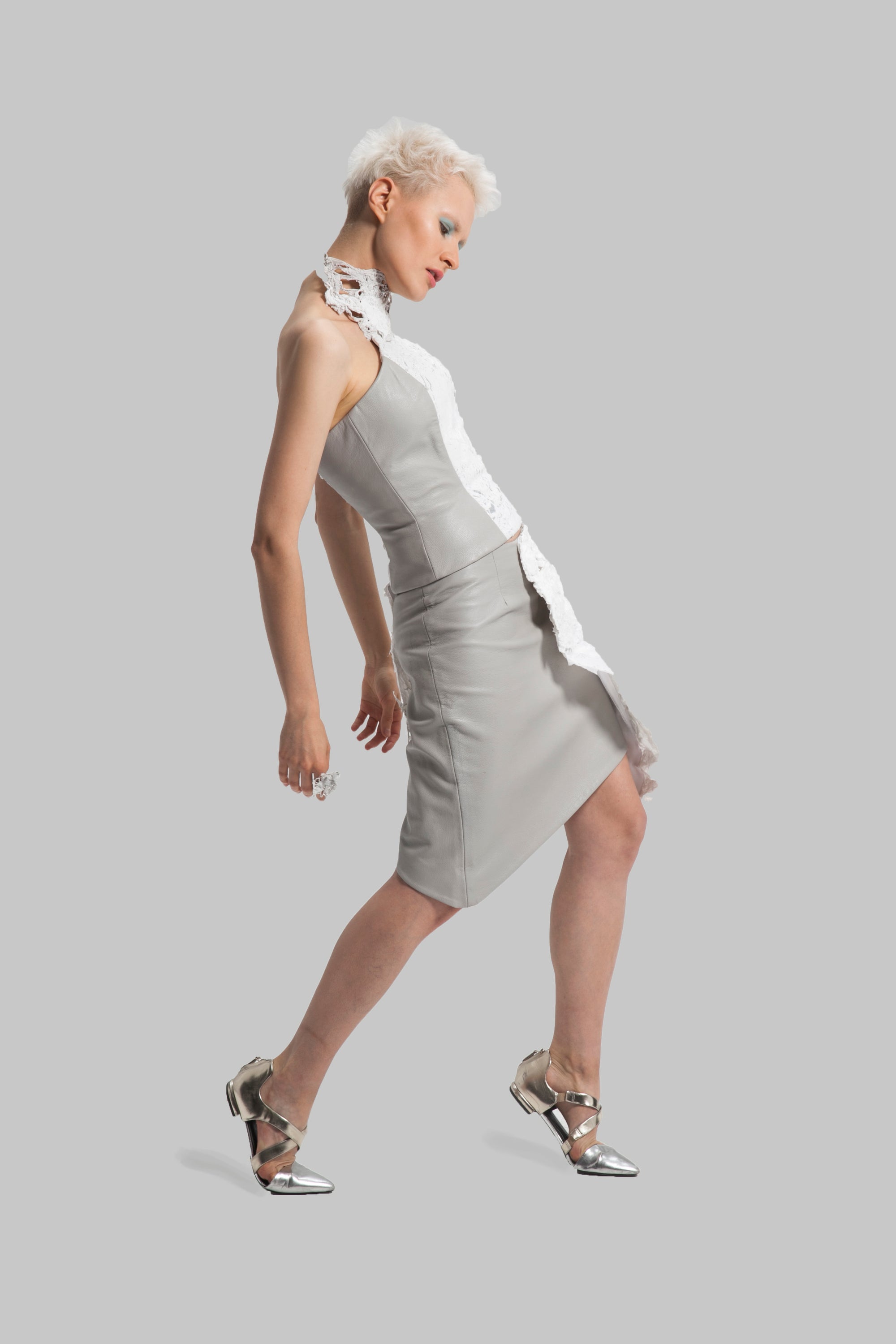 A grey asymmetrical skirt and a corset with details of up-cycled plastic bags as embellishments