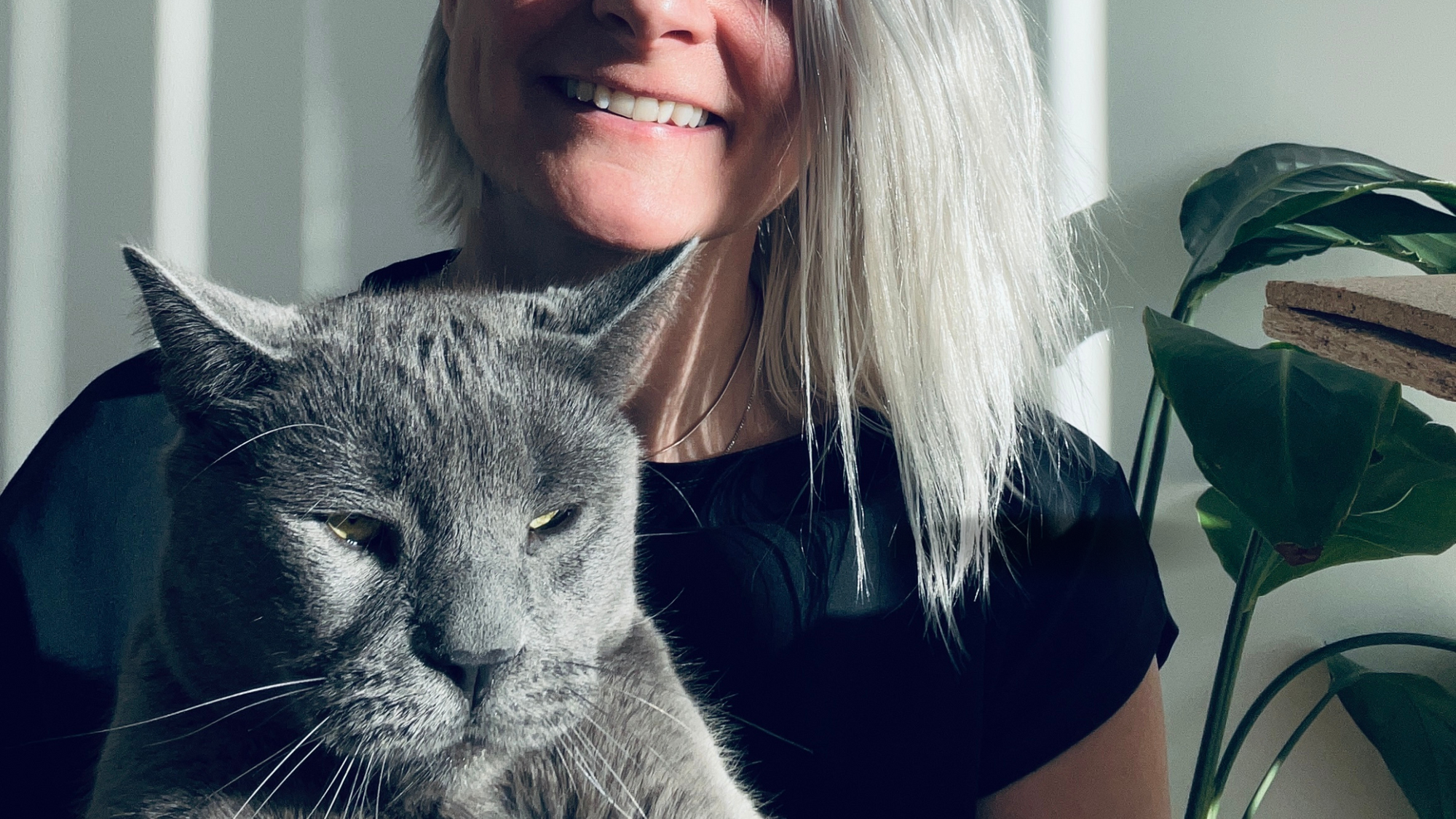 Malaika Boysen Haaning founder of Malaika New York is sitting with her cat Mr. Blob and wishing everyone a lovely galentines