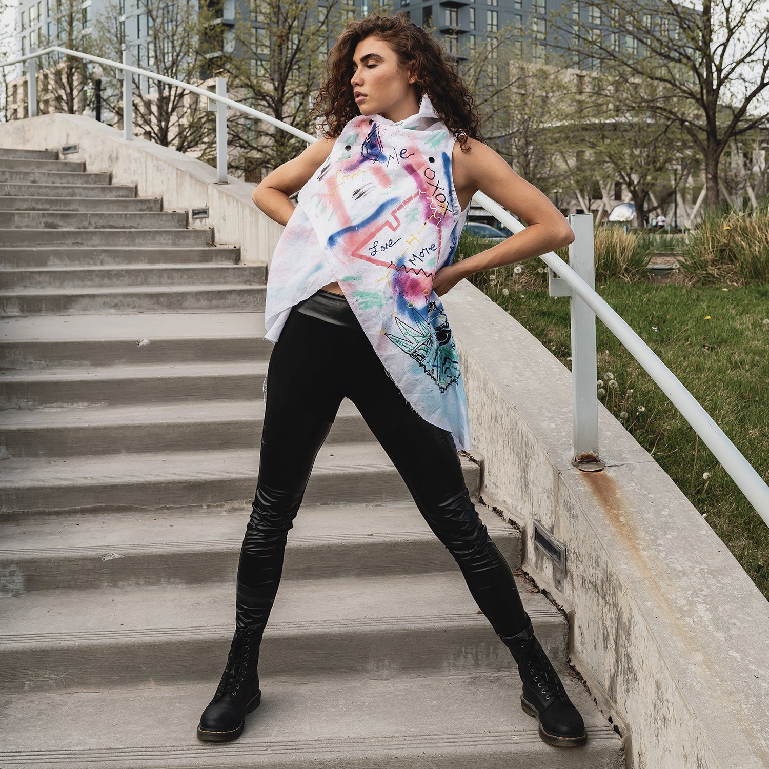 A woman wearing an asymmetrical linen hand painted vest by Malaika New York x Tato side view