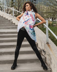 A woman wearing an asymmetrical linen hand painted vest by Malaika New York x Tato side view