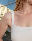 Close of a white sleeveless silk top by Malaika New York