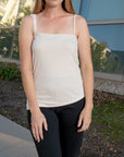 woman wearing a silk sleeveless with black leggings