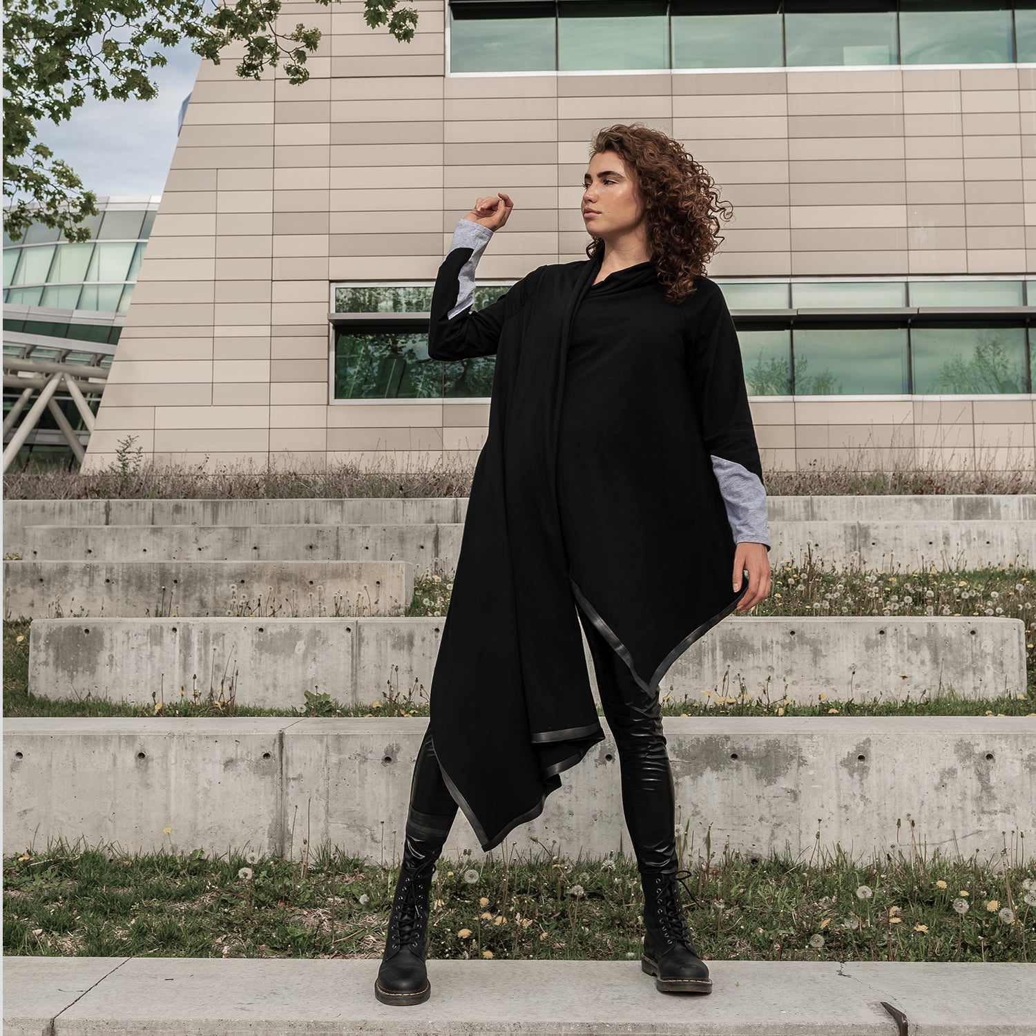 A woman wearing a long black organic cotton cardigan by Malaika New York