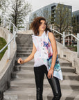 A woman wearing an asymmetrical  colourful hand painted linen vest  Malaika New York x Tato