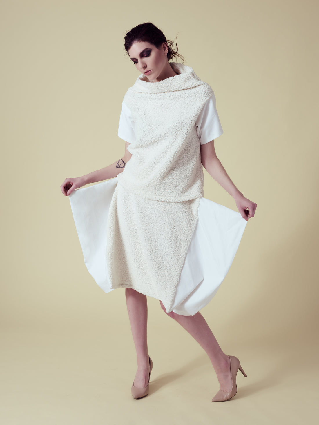 A woman wearing a vegan fur top and skirt by Malaika New York
