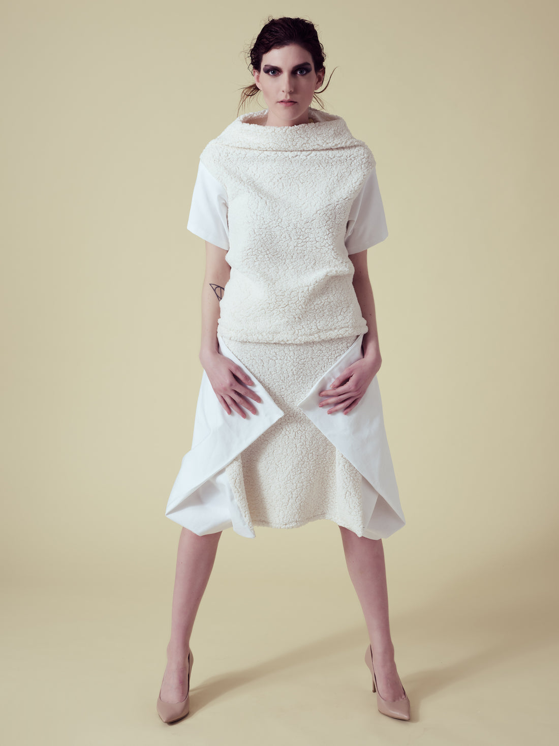 A woman wearing a vegan fur top and skirt by Malaika New York