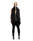 A woman with her back turned wearing a black asymmetrical vest by Malaika New York
