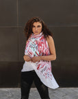 A woman wearing a hand-painted asymmetrical linen vest by Malaika New York