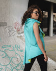 A contoured green asymmetrical vest made in New York