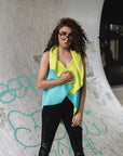A woman wearing a green asymmetrical vest by Malaika New York
