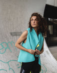 A woman wearing a green asymmetrical vest. A relaxed look by Malaika New York