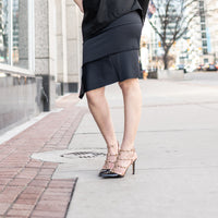 A woman wearing a black body con skirt by Malaika New York. Made in Denmark