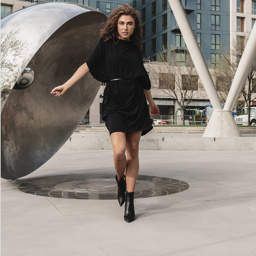 This is a photo of a women wearing our black hexagon t-shirt dress made from organic cotton. This shift dress is great for all body shapes.