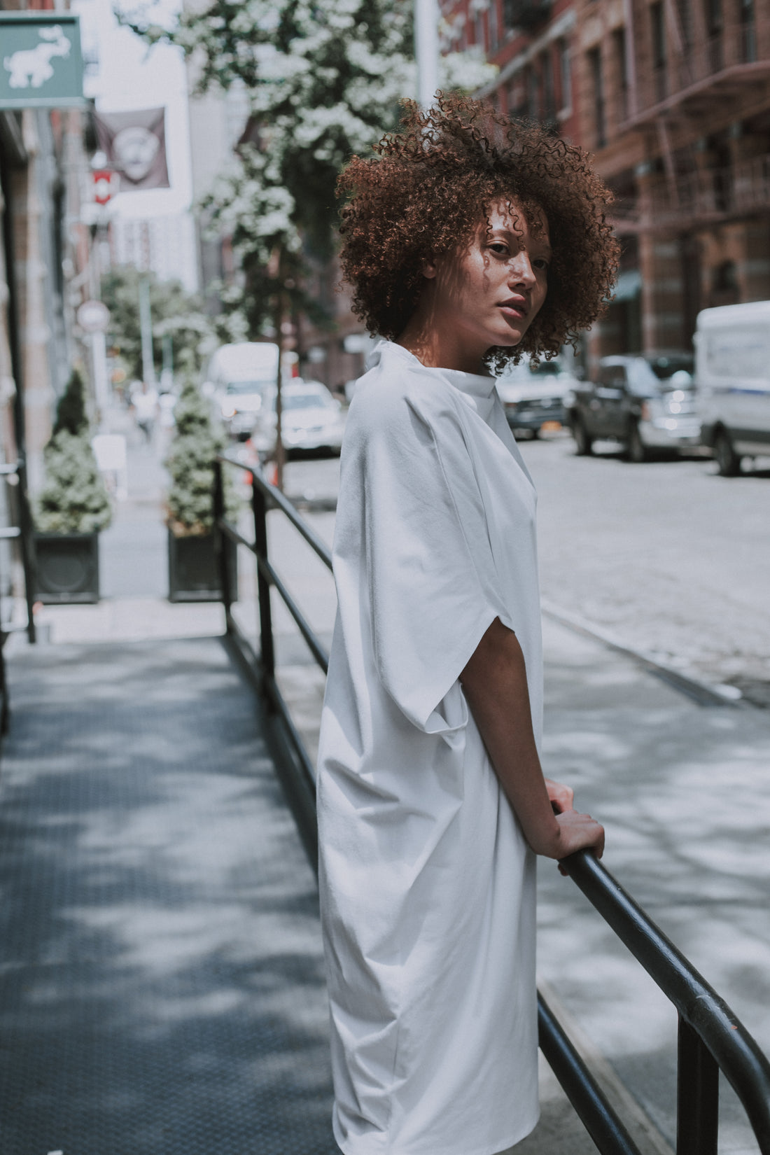 Model wearing our white shift dress in organic cotton. Made by Malaika New York