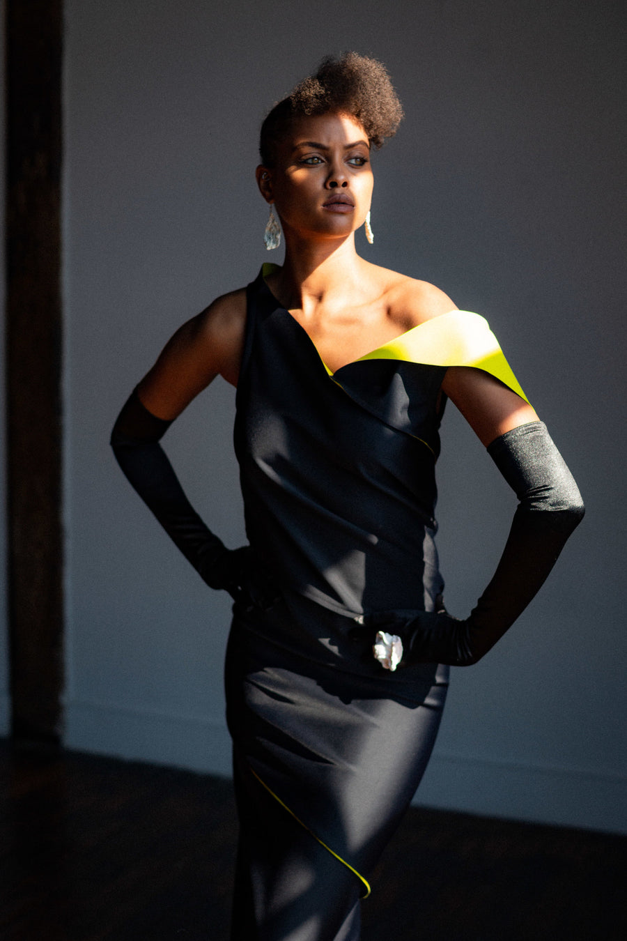 A woman wearing a long bodycon dress by Malaika New York