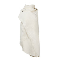 A white faux fur asymmetrical vest with black snaps by Malaika New York