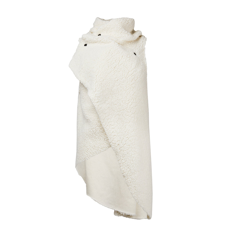 A white faux fur asymmetrical vest with black snaps by Malaika New York
