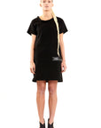 a woman wearing a black organic cotton knee length dress