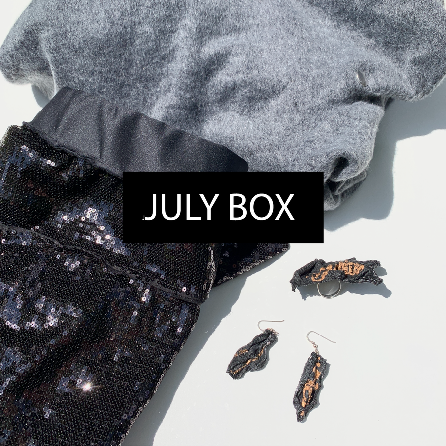 A mystery box from Malaika New York filled with sustainable clothing: a sequins skirt & and grey dress by Malaika New York