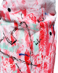 A close up of a hand-painted asymmetrical vest. Mainly red paint mixed with mint green and black by Malaika New York