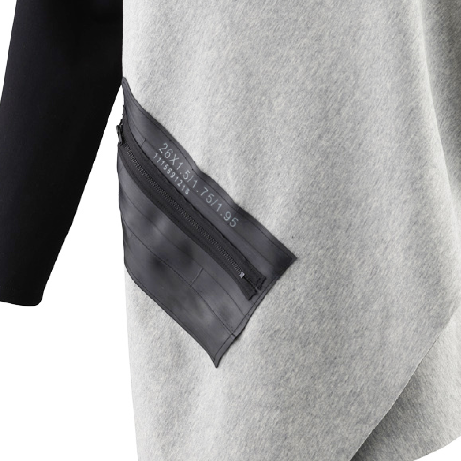 A close up of our grey cardigan with a black zipper pocket and black sleeves by Malaika New York